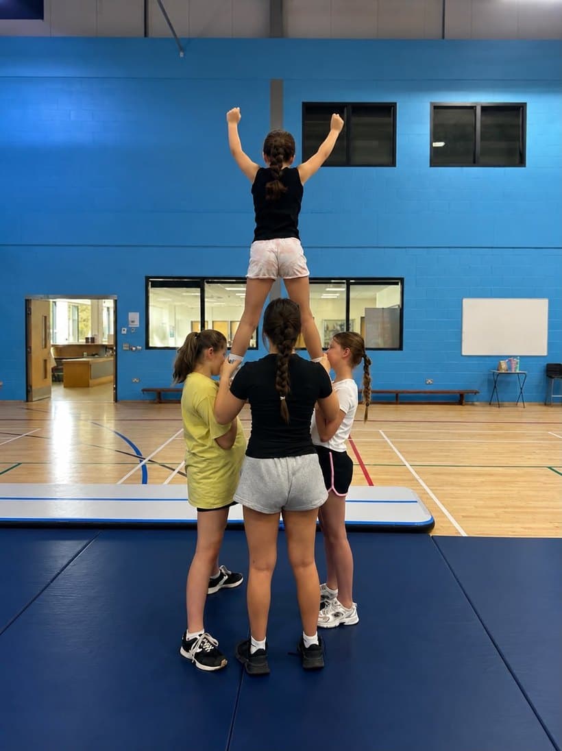 Pixies cheerleaders practising a stunt
